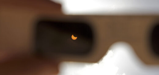 Partial solar eclipse viewed through eclipse glasses